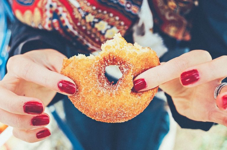 Hands holding a donut