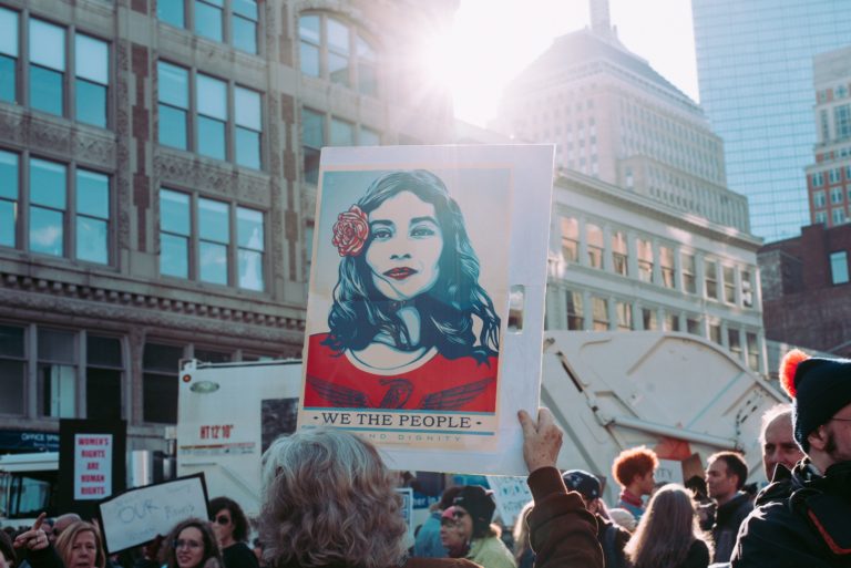 A group of people march in protest.