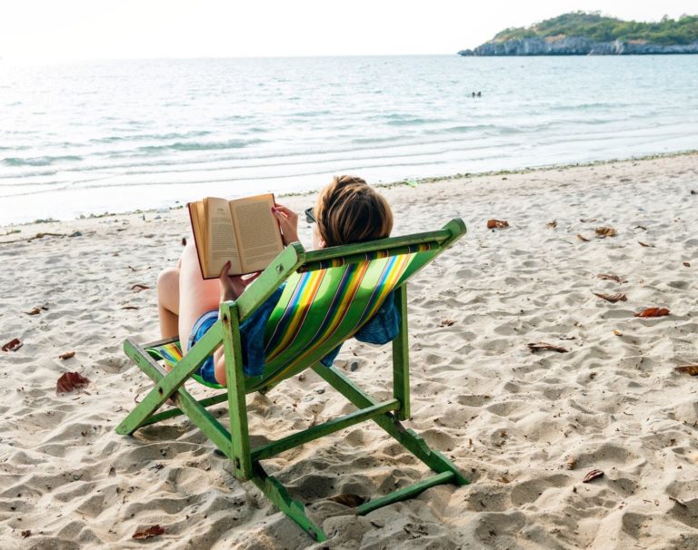 Person reading at the beach
