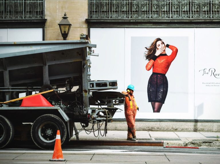 Construction worker in front of a branded display