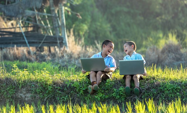 Two children with laptops