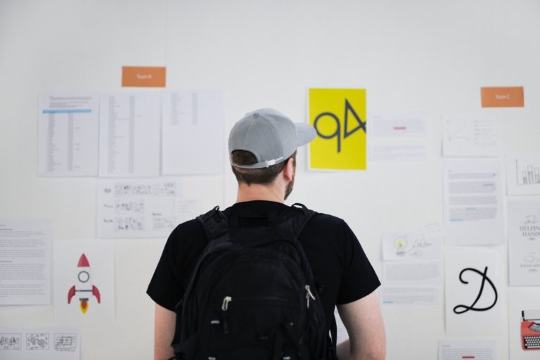 A man looks at a wall of design elements