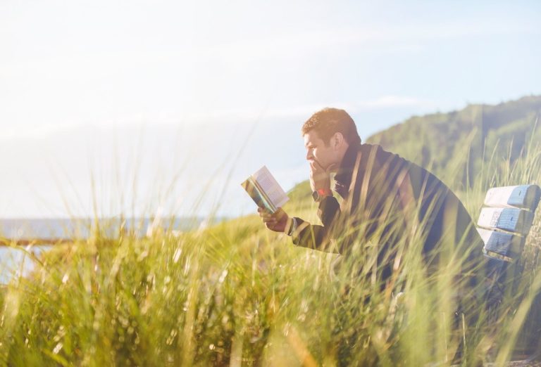 Man reading by the sea