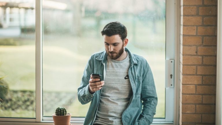 Man using smartphone to check social media