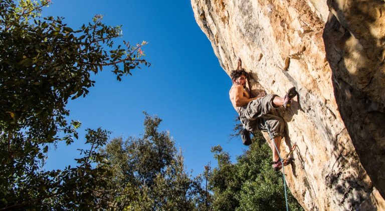 A climber scales a rock face