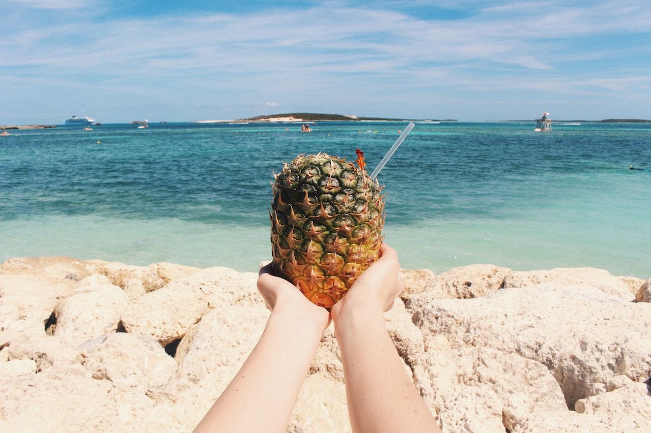seasonality beach drink in a pineapple