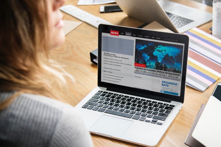 Reading news on a laptop