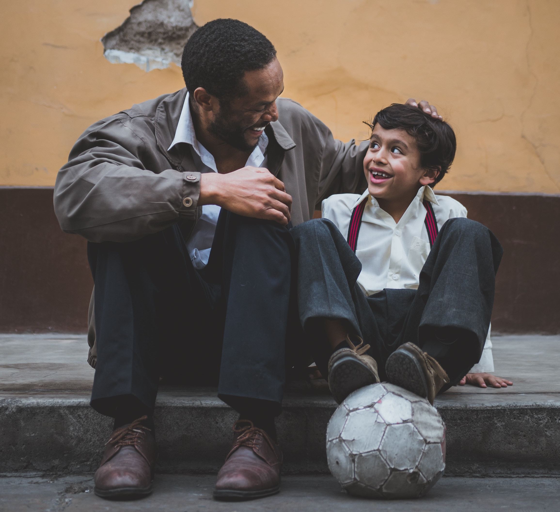 Father and son with soccer ball