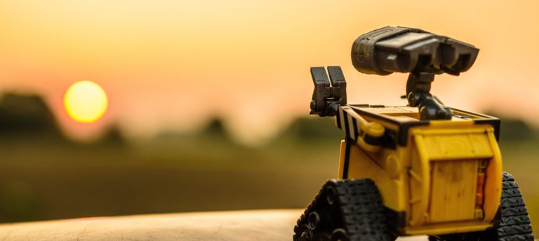 small waving robot and sunset