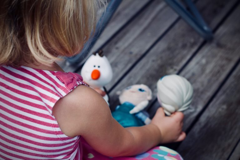 Girl playing with dolls