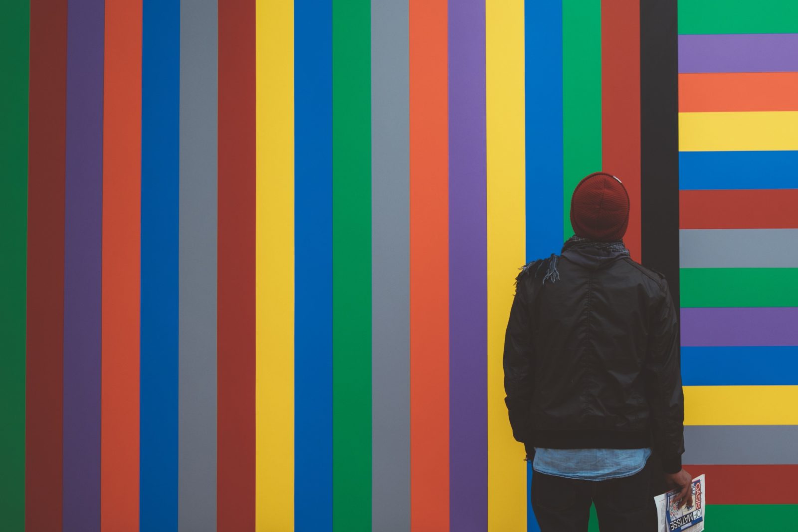 Man looking at wall of colorful lines