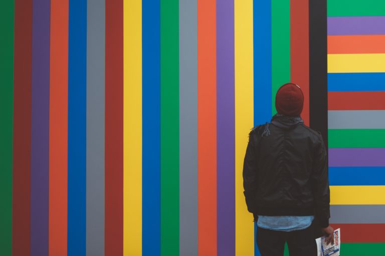 Man looking at wall of colorful lines