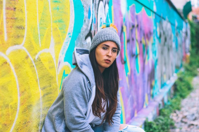 woman in front of colorful wall