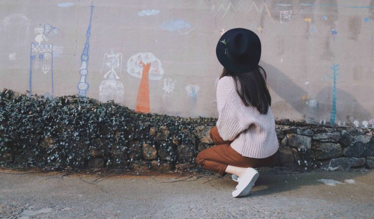 girl looking at chalk drawing