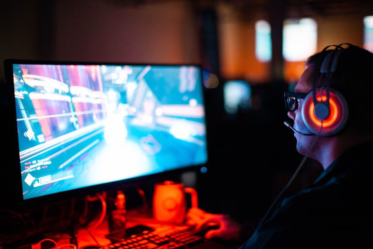 Man playing video games in the dark