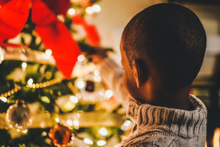 boy in front of Christmas tree