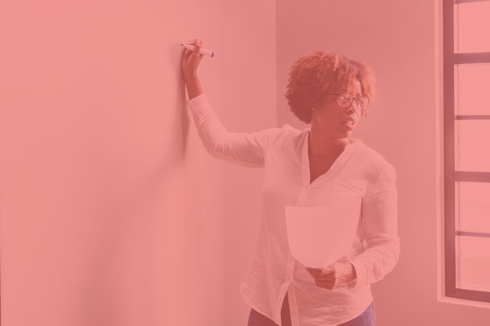 Woman begins charting strategy on a whiteboard