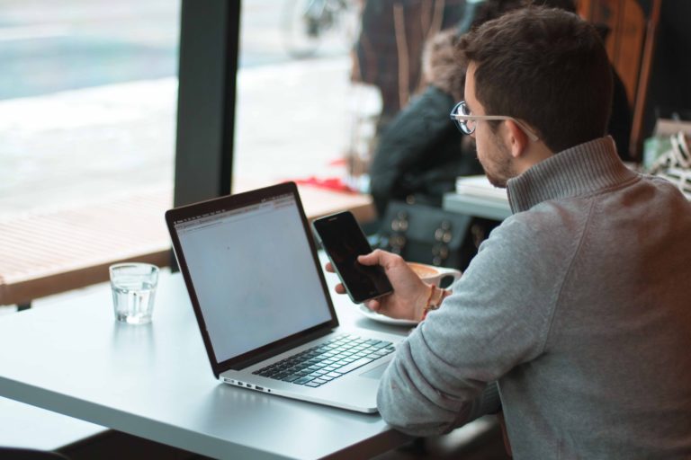 A laptop and notebook on a desk