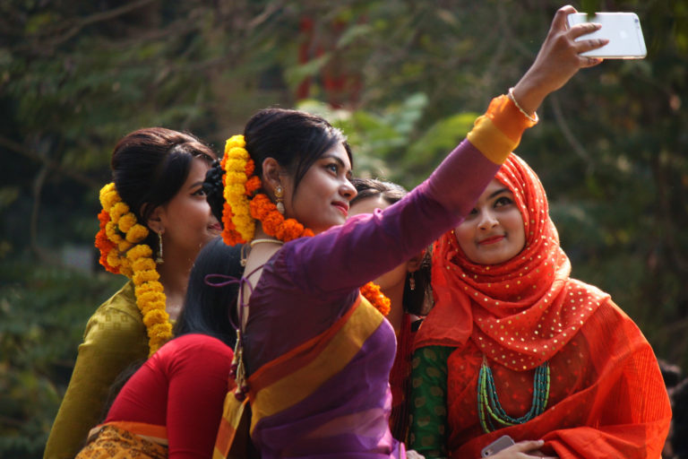 Group of women taking selfie with smartphone