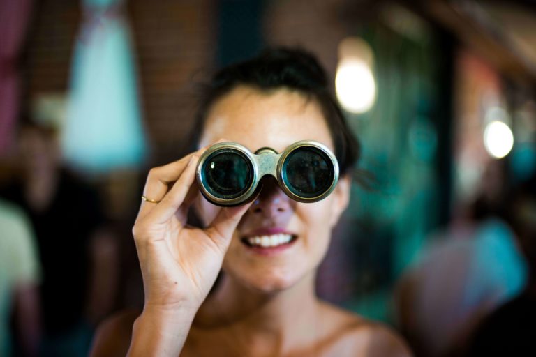 woman looking through binoculars