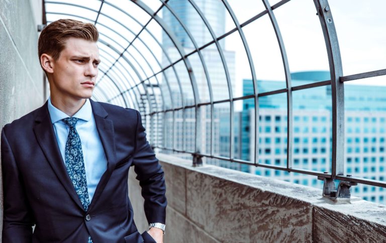 Man standing by windows