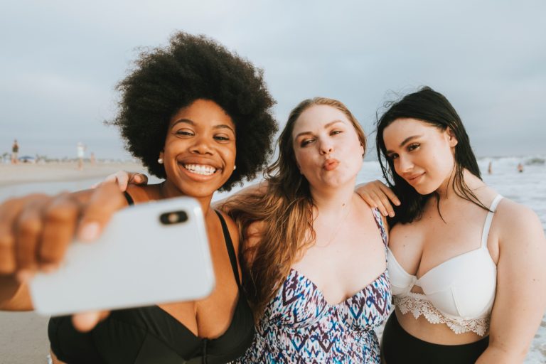 Three women taking a selfie on the beach