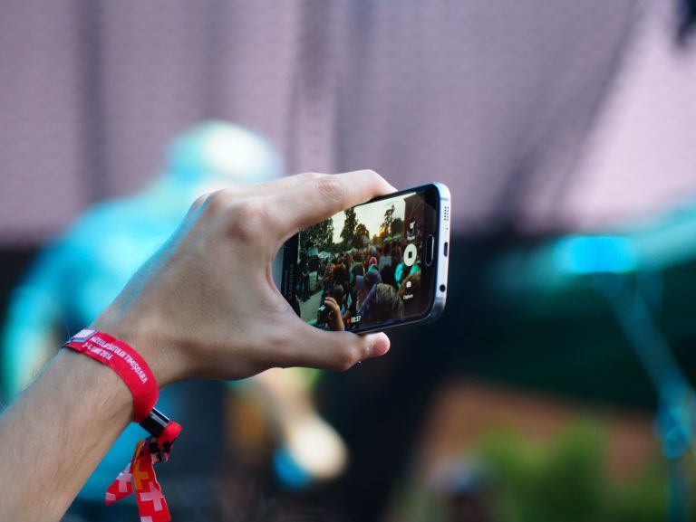 A woman enjoys episodic video content on her smartphone.