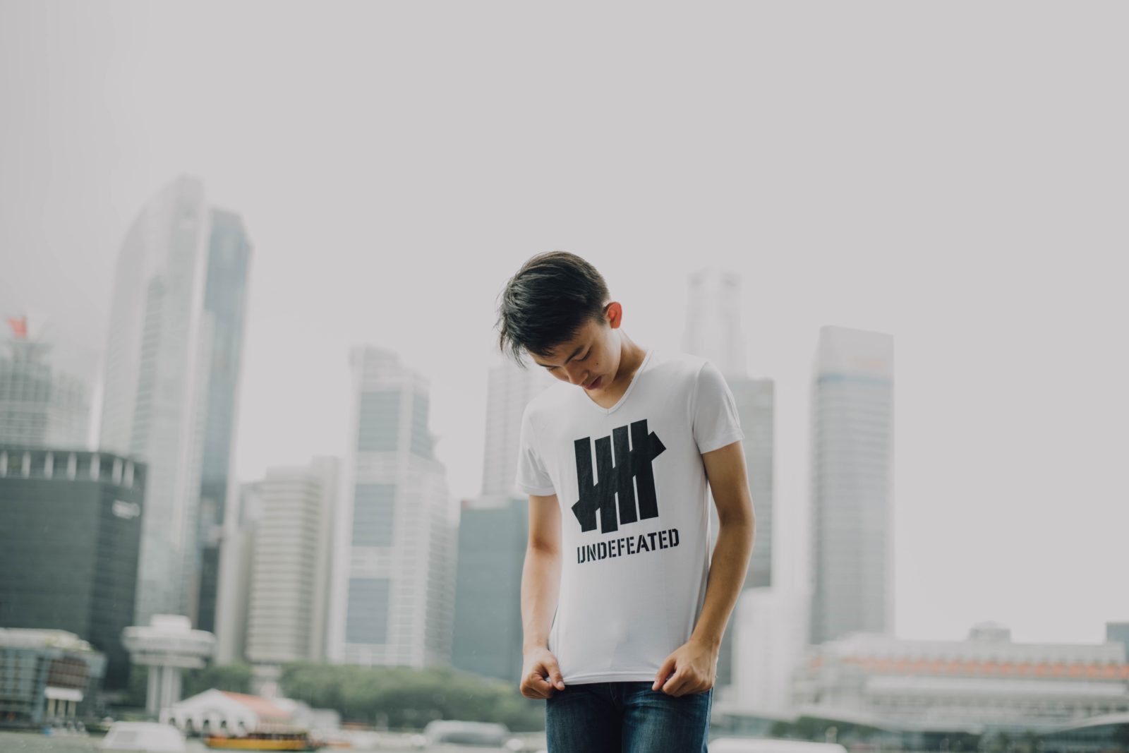 A boy looks down at his sports brand T-shirt.