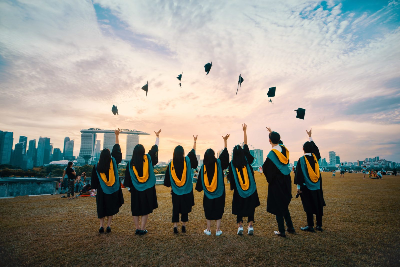 College students throwing their graduation caps in the air.