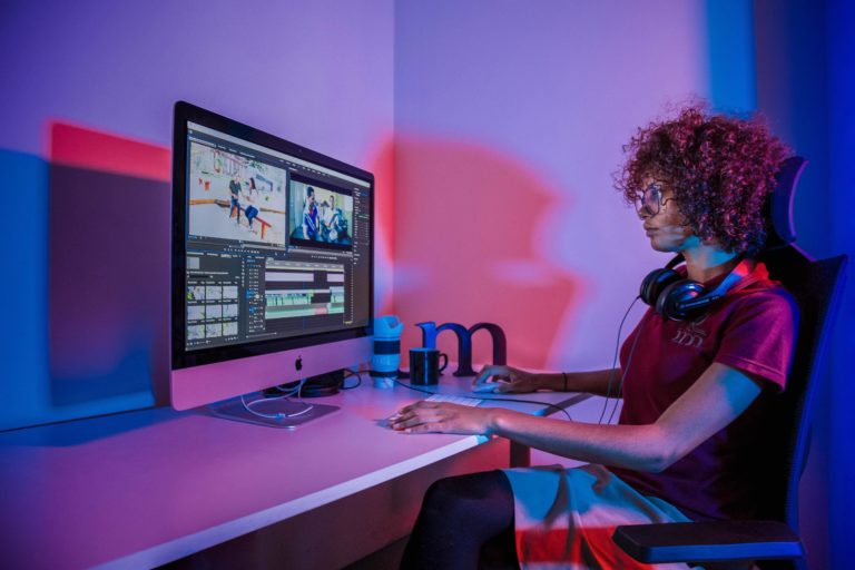 women using computer in colored room