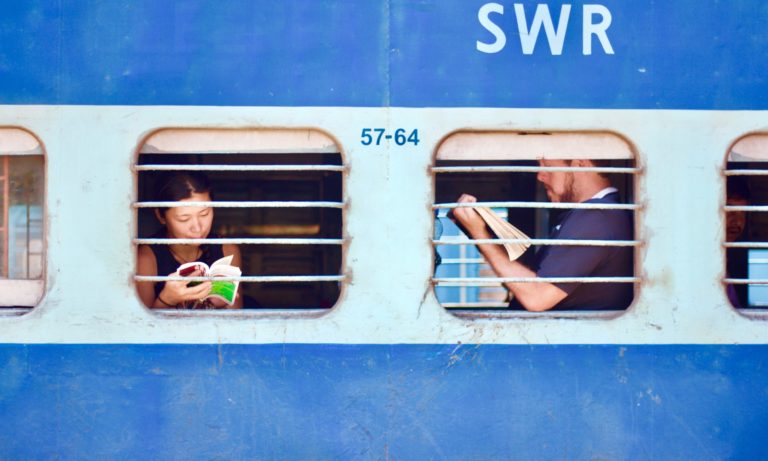 Passengers browse marketing content on their phones while on a train.