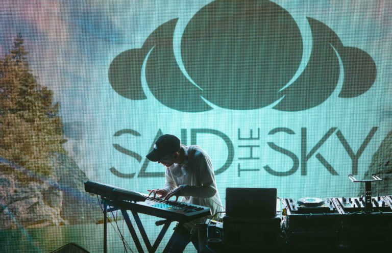 A DJ wearing a baseball cap entertains a crowd at South by Southwest.