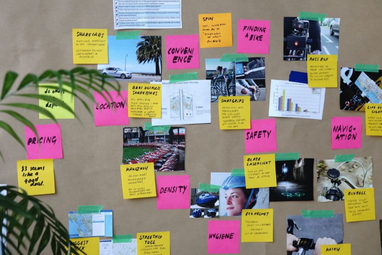 A bulletin board with sticky notes on audience personas.