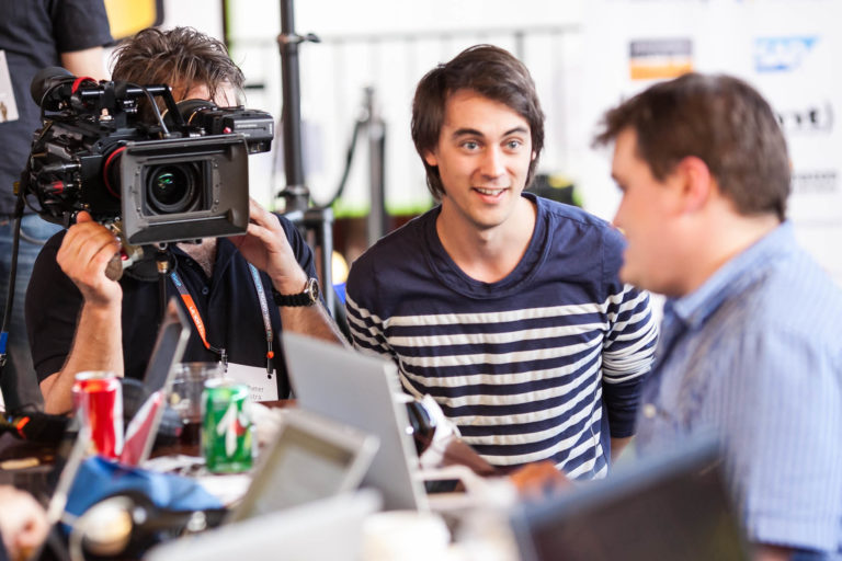 Video production crew in business office.