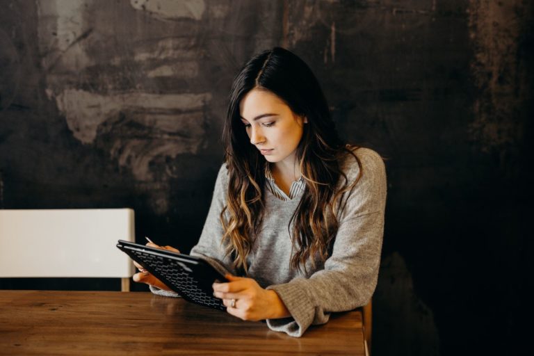 A woman interacts with a LinkedIn ad campaign on her tablet.