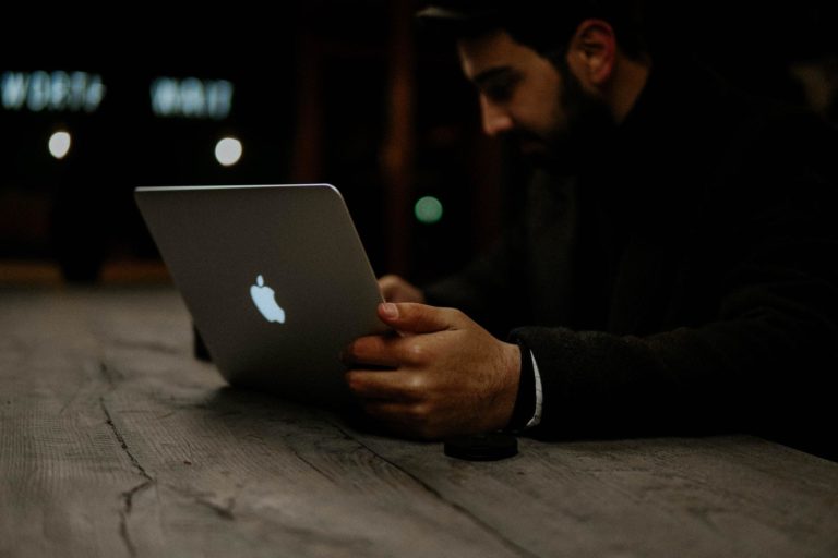 A man uses a new martech solution available on his Mac laptop.