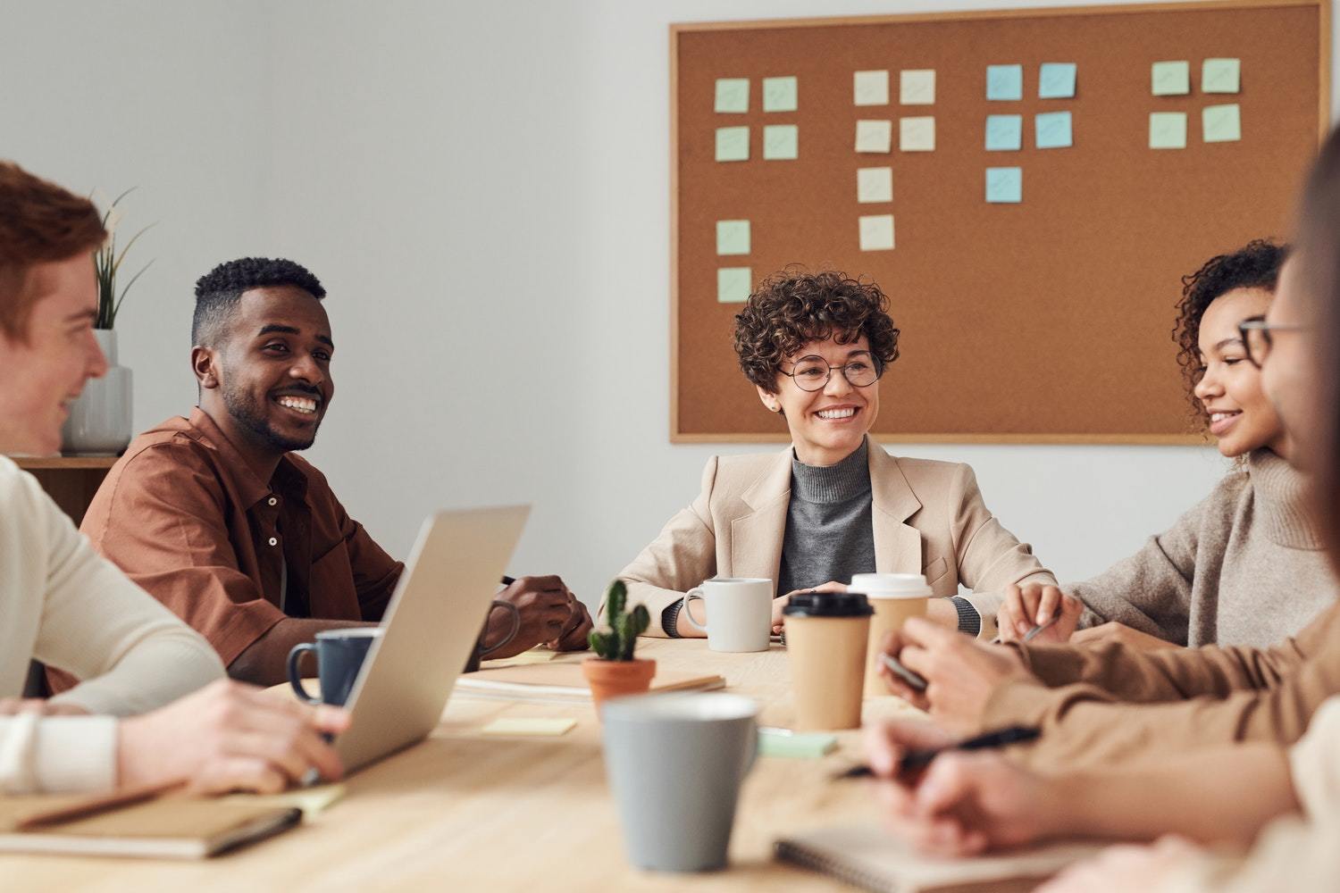 An energized content marketing team, seated at a table and ready to execute on their strategy.