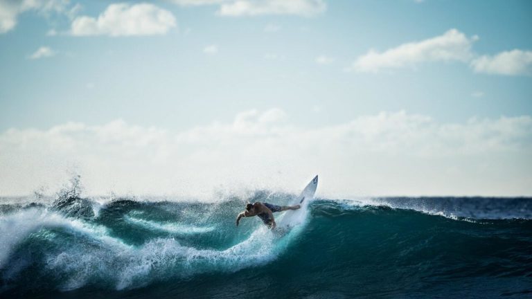 A surfer riding wave in the ocean