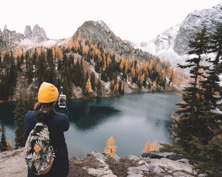 Woman photographs mountain ridge