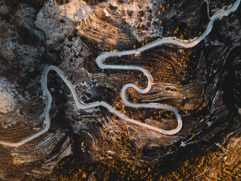 A winding road runs through a canyon.