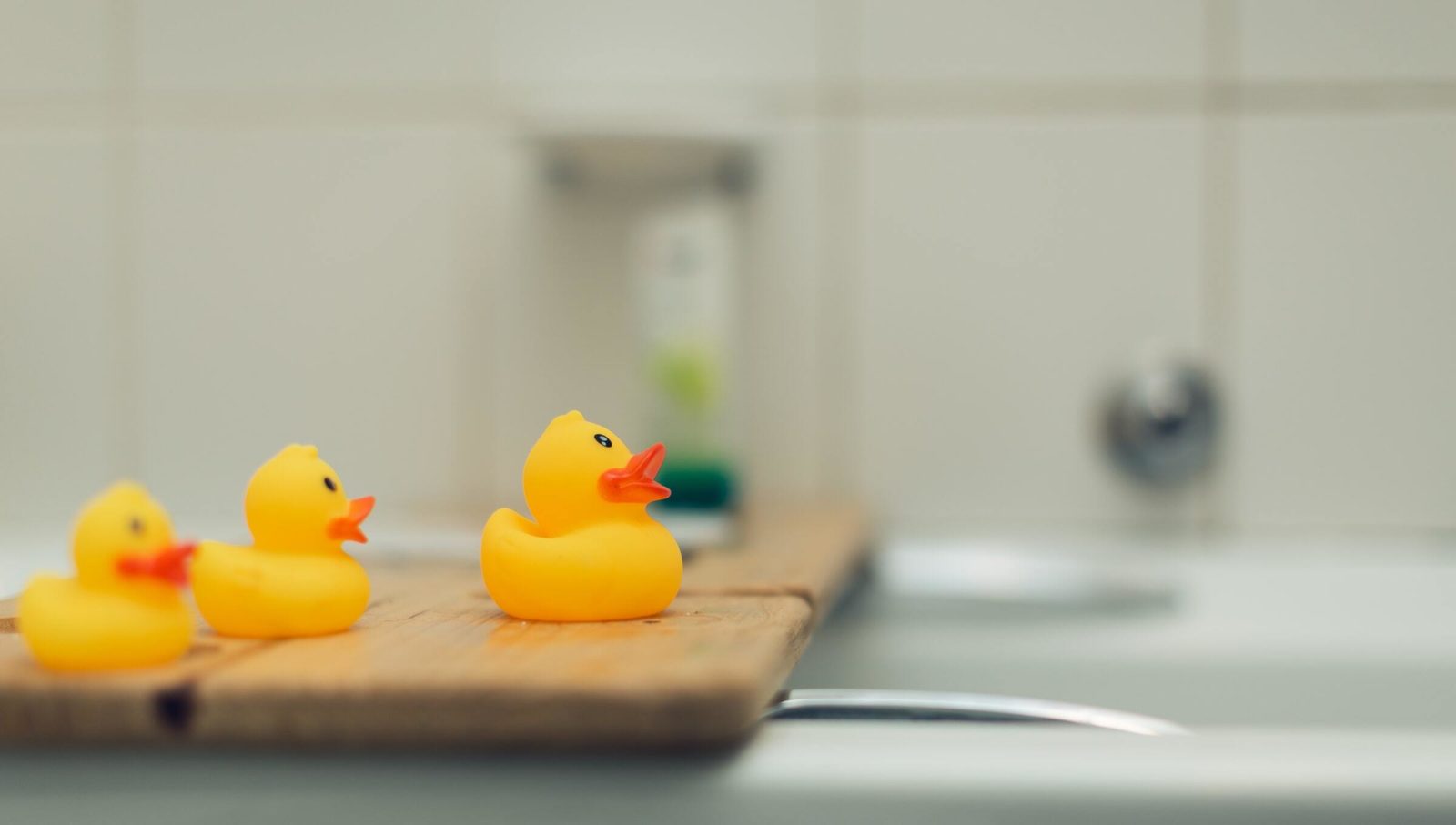 A row of plastic ducks represents an organized content workflow.