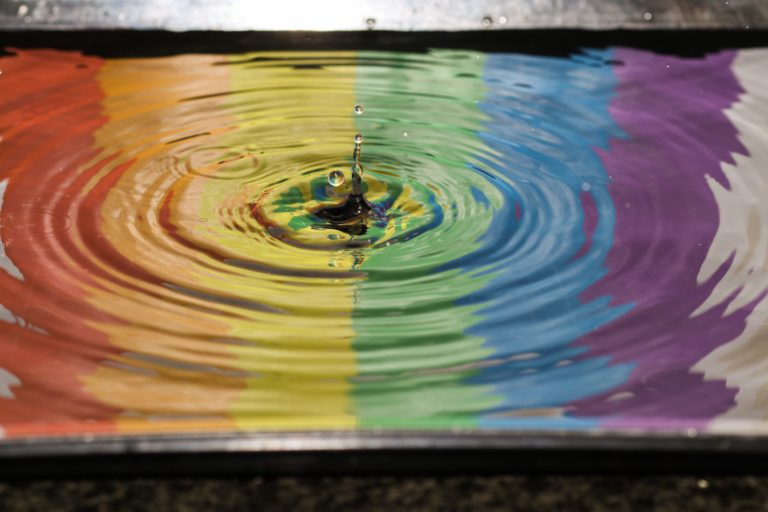 Rainbow reflected in water representing diversity and inclusion.