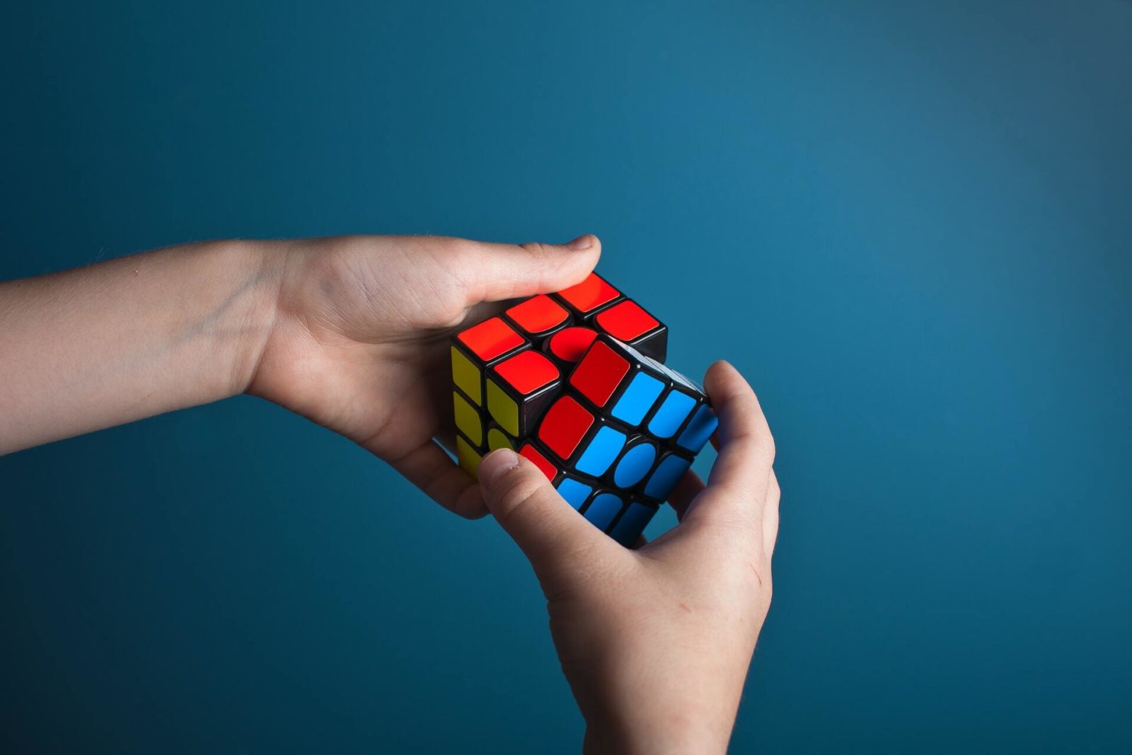 hands holding Rubik's cube