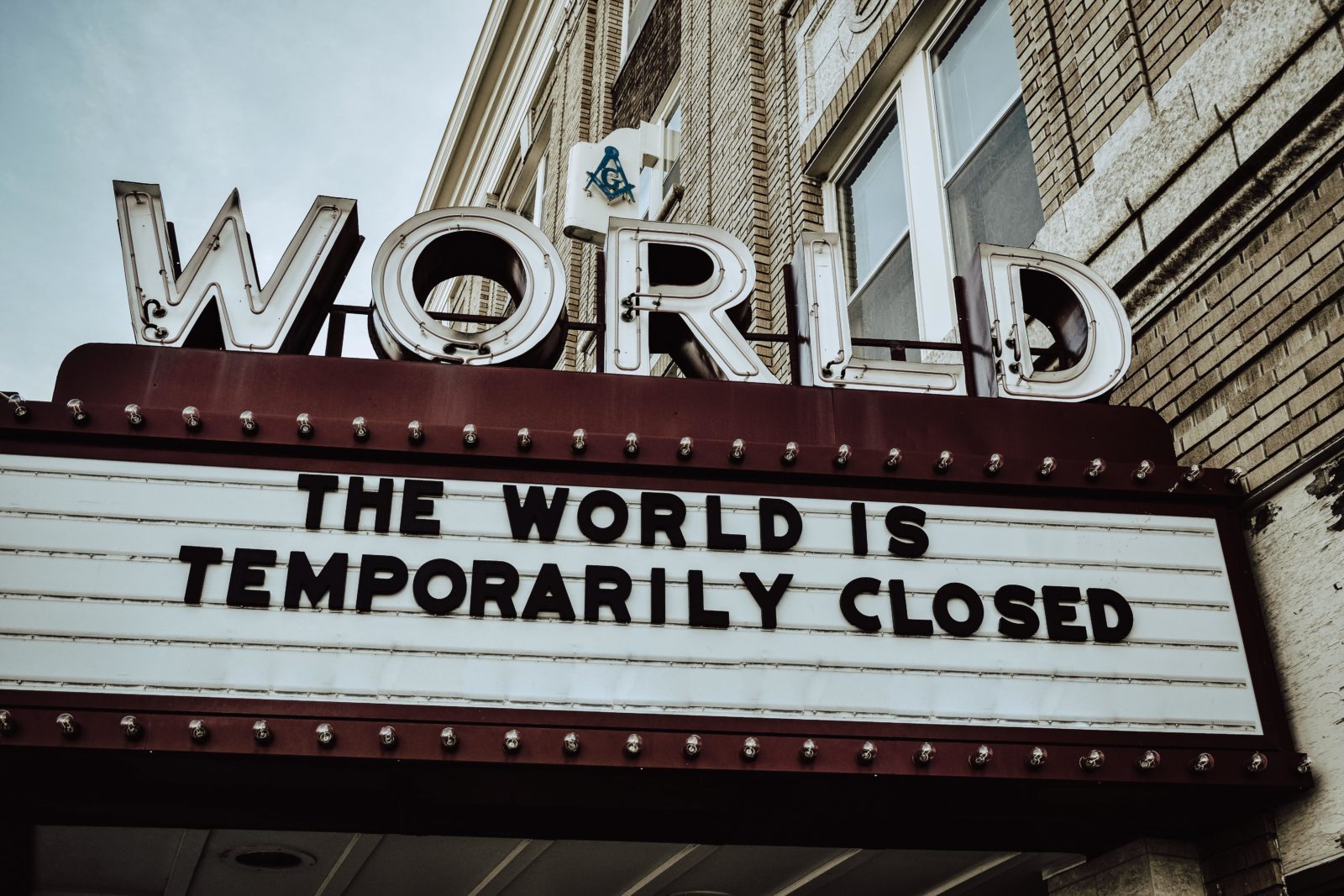 Cinema board announcing "The world is temporarily closed"