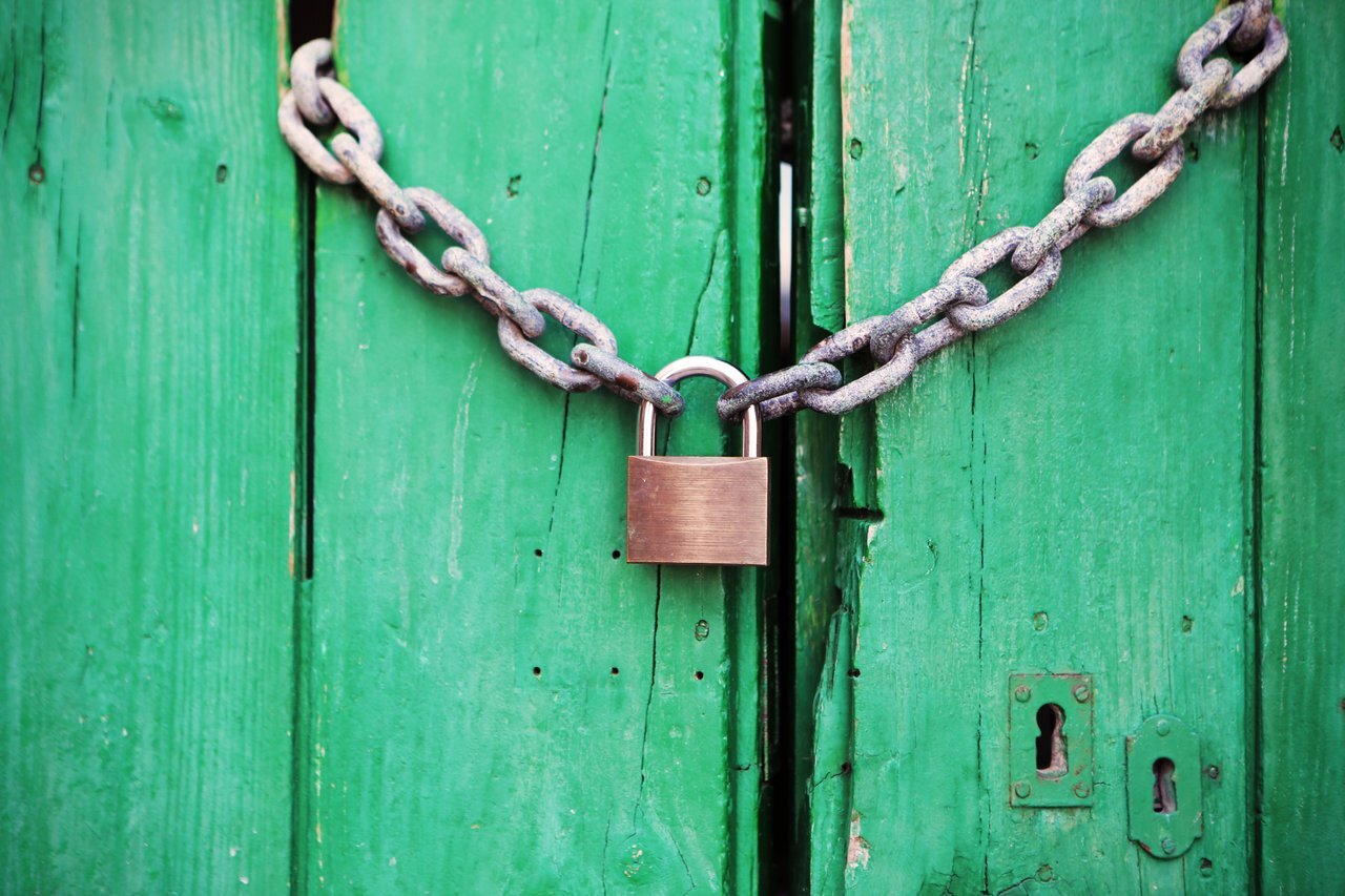 Green door with a padlock