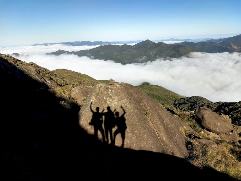 Shadows of a group of friends on a mountaintop