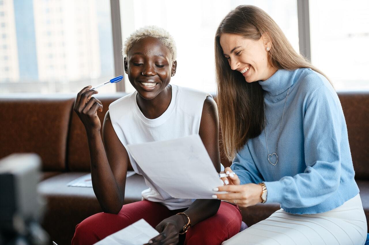 Two employees sitting next to each other.