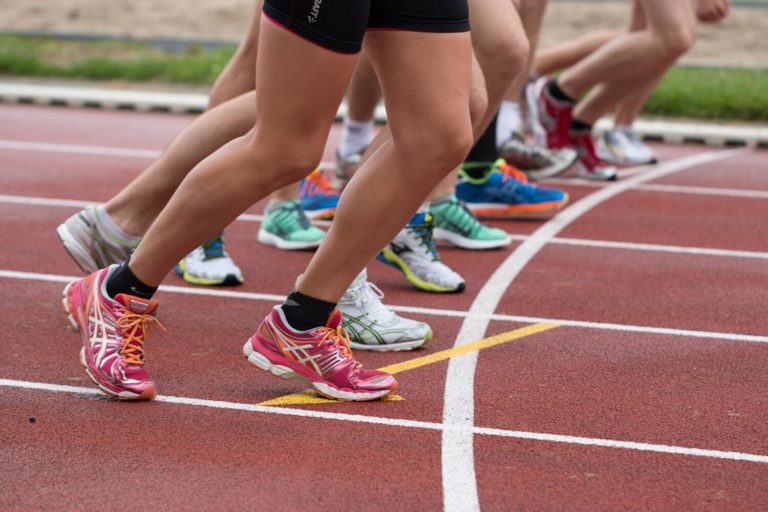 A group of runners in motion as they begin to race