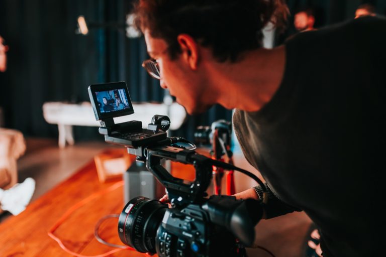 A man operating a video camera.