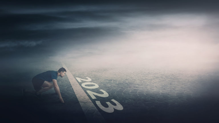 Determined man stands ready in running position at the starting